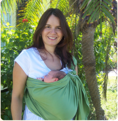 Kinderkarrier model with baby in kinderkarrier baby sling.